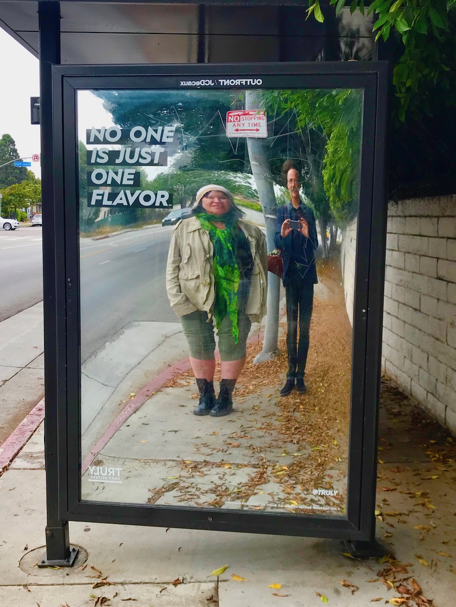 Krist & Darka in distorted bustop reflection.