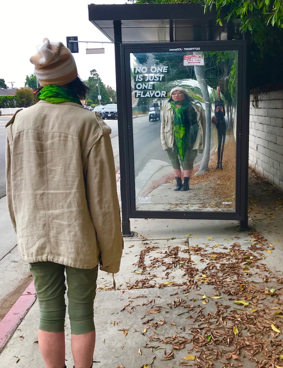 Krist & Darka in distorted bustop reflection.