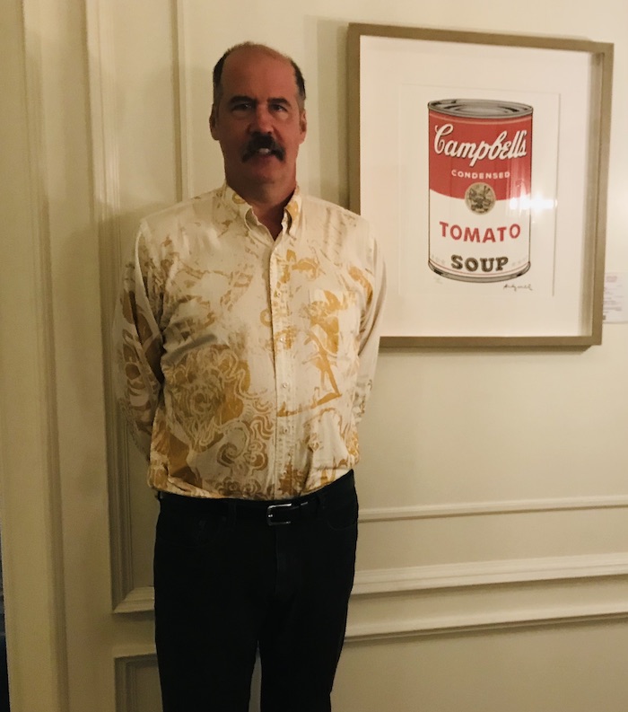 Krist next to Warhol print soup can.