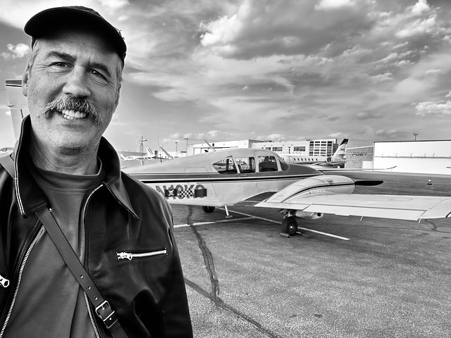 Krist in front of plane.