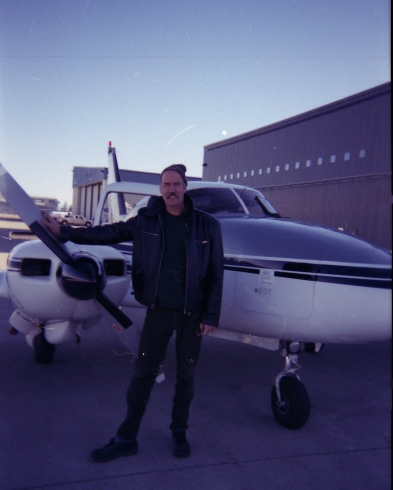 Krist in front of airplane.
