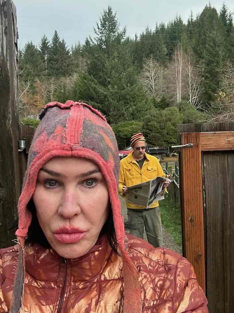 Darka w/ Krist reading paper through gate.