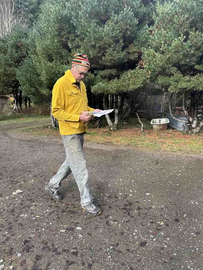 Krist walking, reading paper.